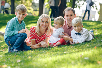 Happy young family with three children outdoors