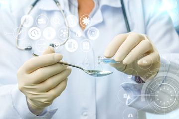 Doctor fills in a spoonful of medicine .