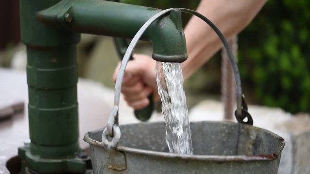Water pump, bucket filled with water