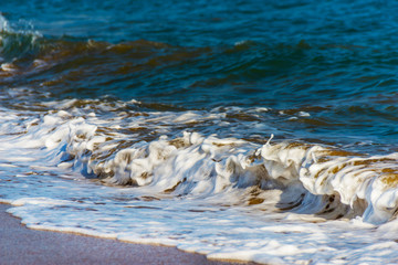 close up of the sea water affecting the sand on the beach, sea waves calmly flowing sand, relaxing...