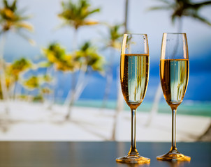 two champagne glasses on the beach - exotic New Year