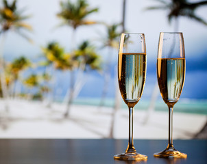 two champagne glasses on the beach - exotic New Year