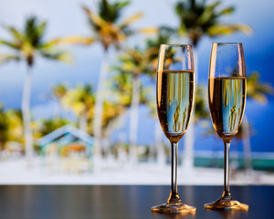 two champagne glasses on the beach - exotic New Year