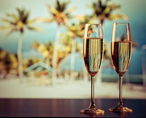 two champagne glasses on the beach - exotic New Year