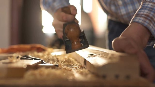 Carpenter planed wood, workplace. Slow motion