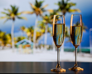 two champagne glasses on the beach - exotic New Year