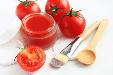 Cosmetic jar of facial homemade mask from bright red fresh ripe tomatoes, closeup. Organic natural body and beauty treatment. 
