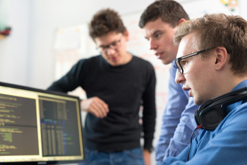 Startup business and entrepreneurship. Young software developers team brainstorming and programming...