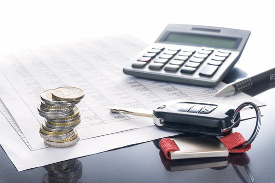 Autokosten und Finanzierung; Autoschlüssel, Auto, Kugelschreiber und Taschenrechner auf Tabellen, Hintergrund, Textfreiraum