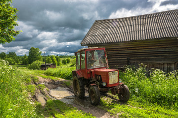 Wheeled tractor on a country road. © Valery Smirnov