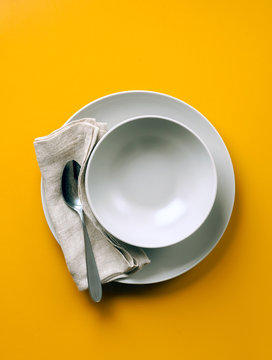 Empty Plate For Soup On A Yellow Background