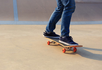 skateboarder legs skateboarding on skatepark ramp