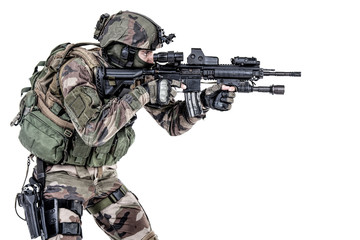Paratrooper of french 1st Marine Infantry Parachute Regiment RPIMA studio shot firing pointing...