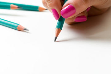 Woman's hand with a pencil