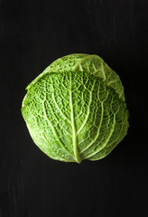 Fototapeta premium Savoy cabbage isolated on black
