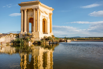 View on the water tower in Peyrou garden with beautiful water reflection during the morning light in Montpellier city in southern France