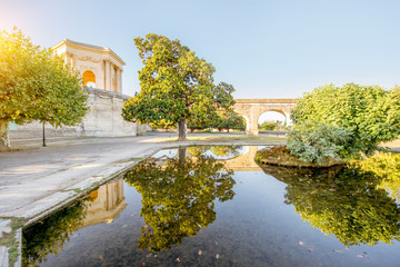Fototapeta na wymiar View on the saint Clement aqueduct in Peyrou garden with water reflection during the morning light in Montpellier city in southern France