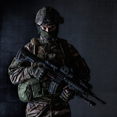 Paratrooper of french 1st Marine Infantry Parachute Regiment RPIMA studio shot firing pointing weapons