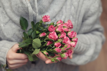 Bouquet of red roses on textile sweater