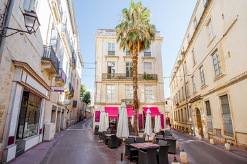 Obraz premium Street view at the old town with cafe terrace in Montpellier city in Occitanie region of France
