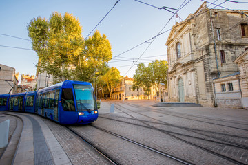 Street view with Saint-Charles chapel and tram during the sunset in Montpellier city in southern France