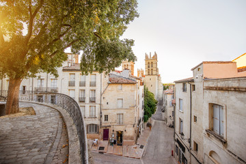 Street view with saint Pierre cathedral at the old town of Montpellier city in Occitanie region of France - obrazy, fototapety, plakaty