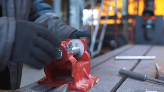 Worker fits the details to each other after drilling and reaming, metal processing, factories and plants, manufactures of metal products