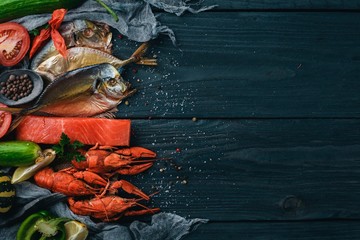 Seafood. Fish Vomer, lobster, salmon. On a wooden background. Top view. Free space for text.