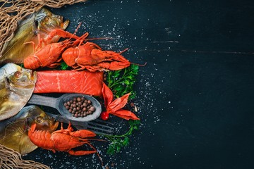 Seafood. Fish Vomer, lobster, salmon. On a wooden background. Top view. Free space for text.