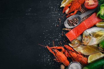 Seafood. Fish Vomer, lobster, salmon. On a wooden background. Top view. Free space for text.