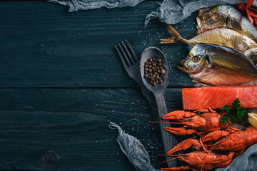 Seafood. Fish Vomer, lobster, salmon. On a wooden background. Top view. Free space for text.