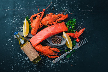 Seafood. Fish Vomer, lobster, salmon. On a wooden background. Top view. Free space for text.