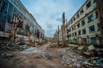 Fototapeta premium Territory of abandoned industrial area waiting for demolition. Junk at former Voronezh excavator factory 