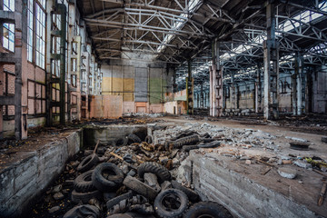 Junk of tires in abandoned industrial hall. Former Voronezh excavator factory
