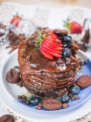 Fototapeta na wymiar pancake with mix fruits (strawberry, blueberry), coffee bean, cookies and honey.