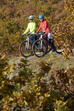 Outdoor sport. Shot of two female cyclists riding a trail.
