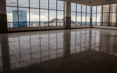 Front view of unfurnished contemporary interior, panoramic city view and daylight