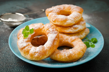 Homemade fried vanilla cottage cheese donuts on a dark concrete background