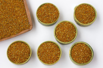 Grain of millet in green boxes. White background. Top view