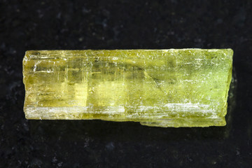 raw crystal of Heliodor (yellow beryl) on dark