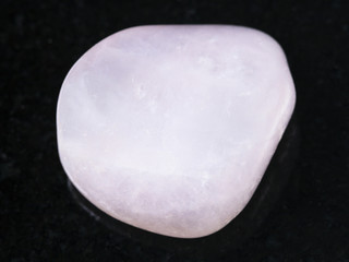 polished pink petalite gemstone on dark