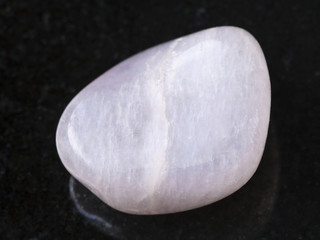 tumbled pink petalite gemstone on dark