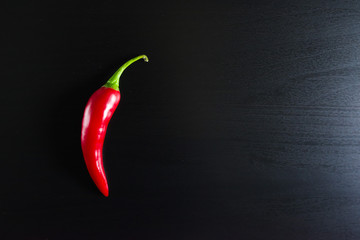Chilli pepper on black background.
