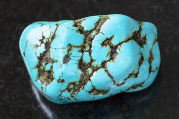 polished blue howlite (turquenite) gem on dark © vvoe