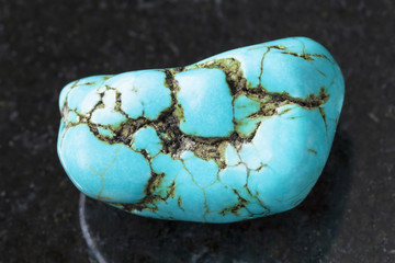 tumbled blue howlite (turquenite) gem on dark