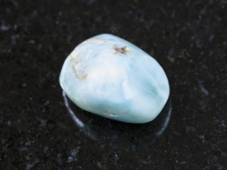 tumbled Larimar gem stone on dark