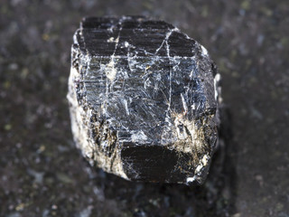 raw crystal of Schorl (black tourmaline) on dark