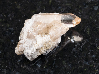 rough crystal of topaz gemstone on dark background