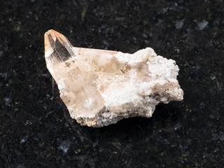 raw crystal of topaz gemstone on dark background