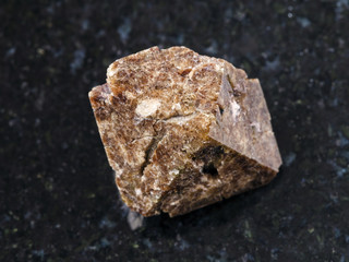 raw crystal of Zircon gemstone on dark background